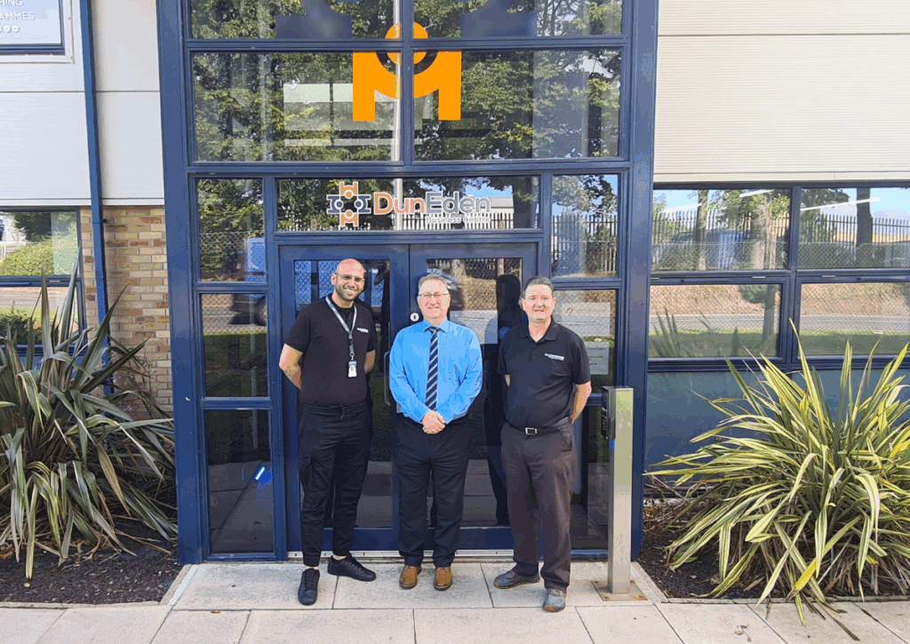 Three men standing in front of Mackenzie Construction's new Dundee hub
